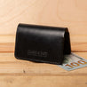 The back of a black leather bifold wallet – a classic gift for him