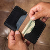 Personalized leather bifold wallet in black shown open, revealing spacious card slots