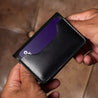 Black mens leather wallet shown in the hands of a man – slim profile, premium craftsmanship