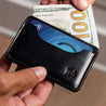 Mens leather wallet held in the hands of a man – handcrafted leather card wallet with slim design in black