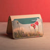 Front view of a personalized leather bifold wallet featuring a field of poppies image printed on genuine leather. Perfect for nature lovers and as a gift for Mother's Day.